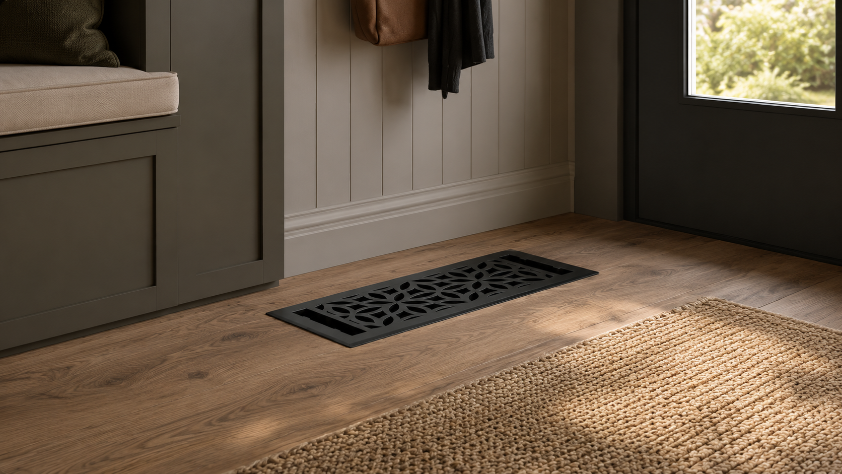 Floor vent on a wooden floor with a bench and coat in the background